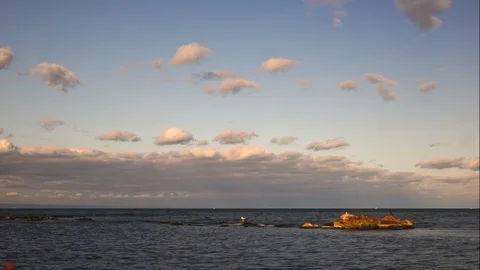 Time interval. 4k. White clouds over the sea. Stock Footage 118444543