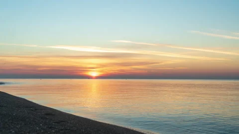 The time interval of sunrise in the sea. The sun rises from under the water and  Stock Footage 227764980