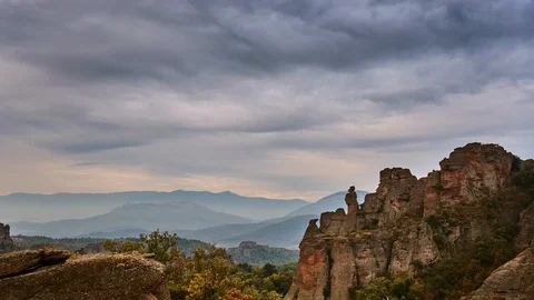 Time interval. view red rocks in the forest, white clouds move across the sky. Stock Footage 116917804