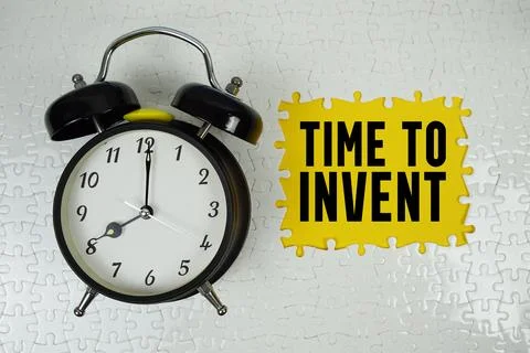 Time To Invent text with alarm clock on yellow background Stock Photos