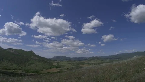 Time laps of clouds fly through the blue sky over the mountains Stock Footage 90839385