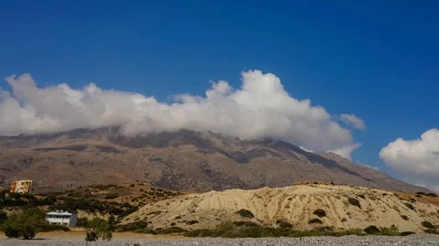Time laps of clouds fly through the blue sky over the mountains Stock Footage 98334478