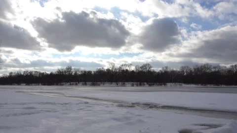 Time laps clouds on the winter sky and snowy river Stock Footage 147655008