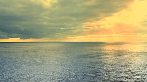 Time laps. Dramatic Golden Sunset Over Calm Ocean With Sun Rays and Storm Clouds Stock Footage 327235461