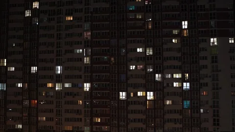 Time Laps a night view of a house in which people stay at home, the windows turn Stock Footage 129305853