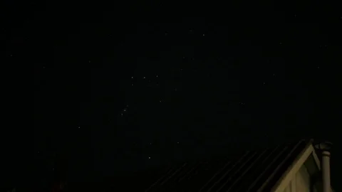 Time laps starry sky at night. Slate roof with chimney. Video stock 74619805