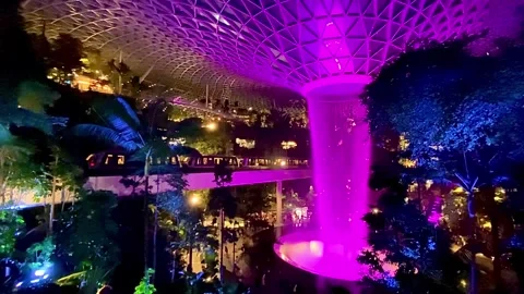 Time Laps Train Passing Behind Fountain at Changi Airport, city view Stock Footage 313652824