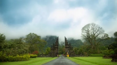 Time lapse 4k. Balinese gate behind which the mountains and swirling clouds Stock Footage 41192697