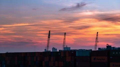 Time-lapse 4K : Cranes lifting containers background sunset in the evening. Stock Footage 121773524