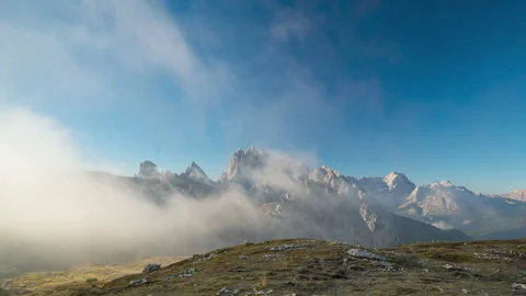 Time lapse in 4k of fog moving in dolomite mountains on sunny day Stock Footage 213611154