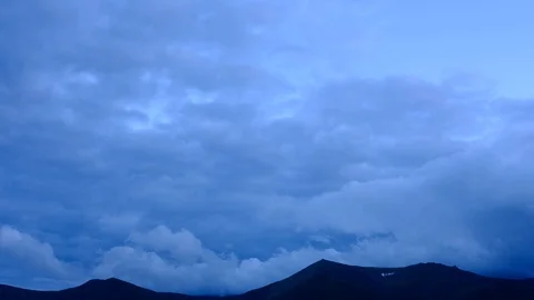 Time lapse 4K footage of cloudy blue twilight sky over mountain ridge Stock Footage 93890409