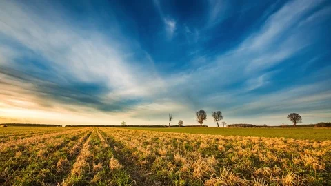 Time lapse 4k landscape of sunset sky over stubble field at spring in Poland Stock Footage 73530695