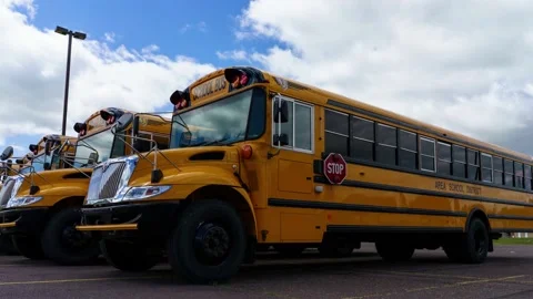 Time lapse 4k school bus at parking lot on a clear day, the sky is clear. Stock Footage 199086269
