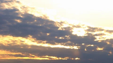 Time Lapse 4K. Sunrise. Rays of the sun break through the orange, purple clouds Stock Footage 120937346