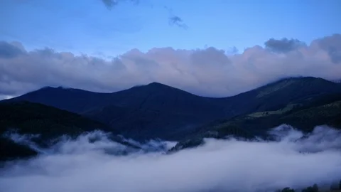 Time lapse 4K video of clouds and fog moving at mountain valley Stock Footage 91930381