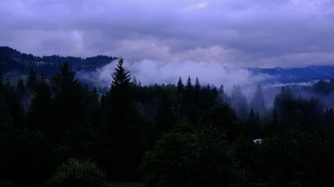 Time lapse 4K video of clouds and fog moving at mountain valley at cloudy rai Stock Footage 92239326