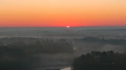 Time lapse Aerial (drone) footage of the sun rising over orange clouds Stock Footage 144096853