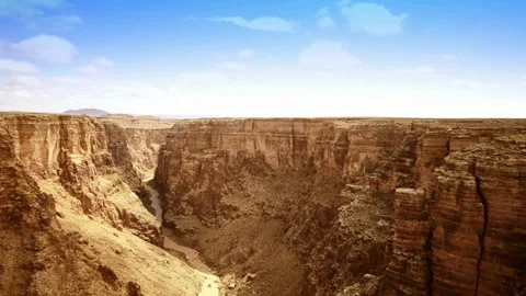 Time-lapse Aerial point of view over desert brush and cliffs of Grand Canyon in Stock Footage 336578169