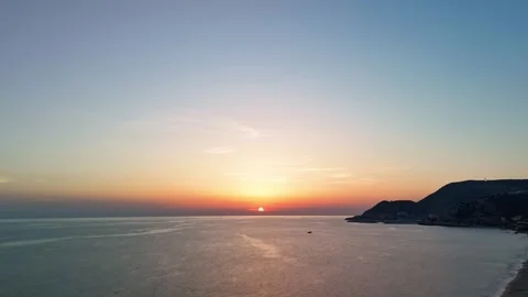 Time-lapse aerial sunset over the sea with coastal landscape Stock-Footage 304873007