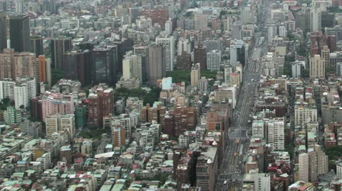 Time-lapse aerial view of city traffic, zoom out to urban sprawl, Taiwan Stock Footage 57108202