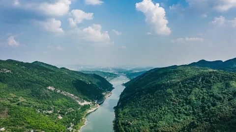 Time-Lapse Aerial View of Lush Green Mountains and Clear Blue Summer Sky Stock Footage 341909641