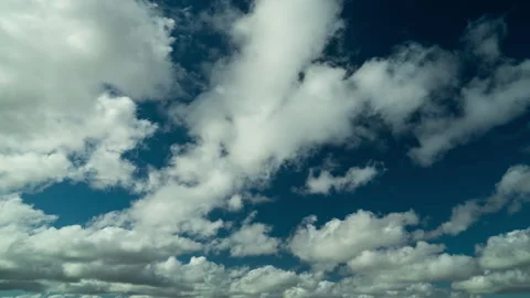 Time-lapse. Against the background of the blue sky , beautiful white , fluffy Stock Footage 255593439