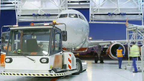 Time-Lapse of a Aircraft Maintenance Hangar Where New Airplane is Toed by a Tug Stock Footage