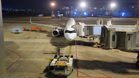 Time-lapse of airplane baggage loading and pushback, night departure Stock Footage 320117579