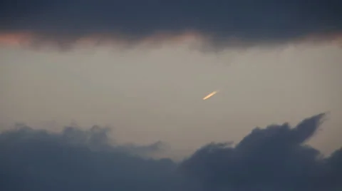 Time lapse of airplane flying into storm clouds at sunset Stock Footage 59130108