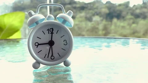 Time lapse of alarm clock with blurred nature background Stock Footage 173580658
