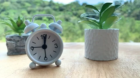 Time lapse of alarm clock with hill and nature background Stock Footage 177937320