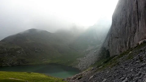 Time lapse on the Alps, light sun through clouds, green lake Stock Footage 112044453