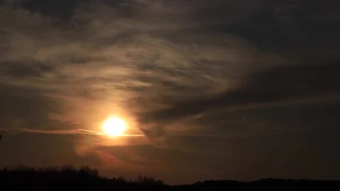 Time lapse amazing sunset shining through soft clouds going to darkness. 4K Stock Footage 130352170