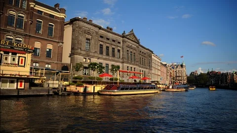Time Lapse of Amsterdam Skyline with Ferry Boats Passing on Amstel River Canal Video stock 104518939
