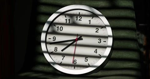Time lapse of analog wall clock with window blind shadow in sunlight Stock Footage 341854230
