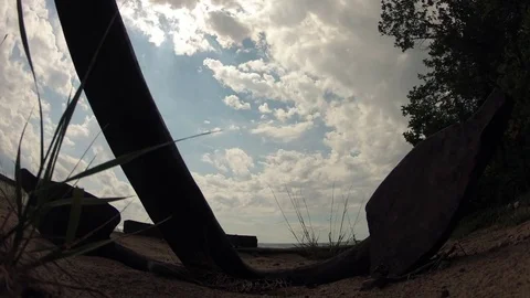 Time Lapse Anchor on Sandy Beach, Sun Beams and Moving Clouds Stock Footage 85372559