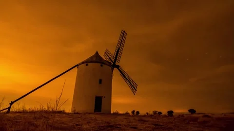 Time lapse of ancient windmill under dramatic golden night sky in spain. Stock Footage 337803336