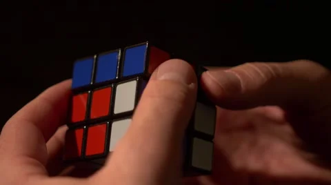 Time lapse and a close up shot of a mans hands solving the Rubik´s cube Stock Footage 60672396