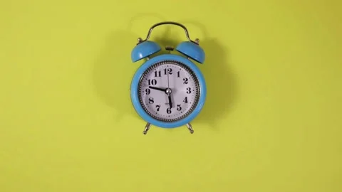 Time-lapse animation of a blue, classic, analogue alarm clock moving. Stock Footage 166147661