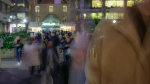 Time lapse - anonymous crowds of people at night with city lights Stock-Footage 123425615