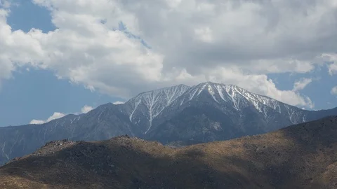 Time lapse of approaching cloud shadows above a snow covered Mount San Jacinto Stock Footage 108990461