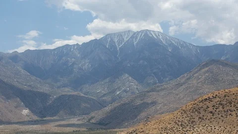 Time lapse of approaching clouds and shadows on a snowy Mount San Jacinto Stock Footage 108993401
