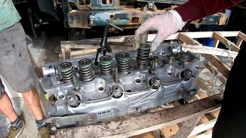 Time lapse assembly of springs and valves of an outboard cylinder head Stock Footage 171863345