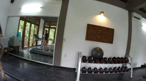 Time-lapse of athletic young man running on treadmill bare footed 4k Stock Footage 55461736