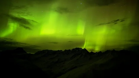 Time-lapse of Aurora borealis over the snowy mountains in winter Stock Footage 113249637