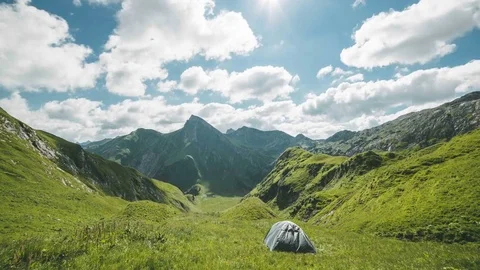 Time-lapse of the Austrian alps with a tent and watching clouds move by quick Stock Footage 85020645