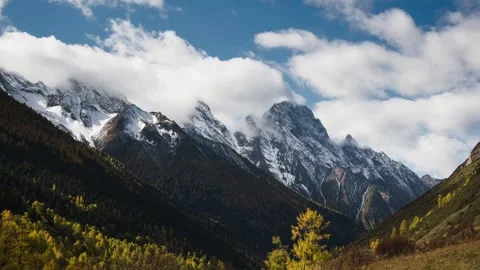 Time-Lapse of Autumn Forest and Snow Peaks with Moving Clouds Jiesigou, Western Stock Footage 320352281