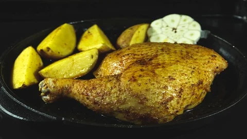 Time lapse. baked chicken leg and potatoes in the oven, cooking process closeup Stock Footage 122641553