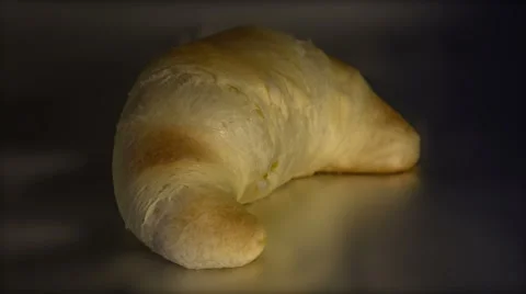 Time lapse baking of single golden and crisp croissant Stock Footage 49003841