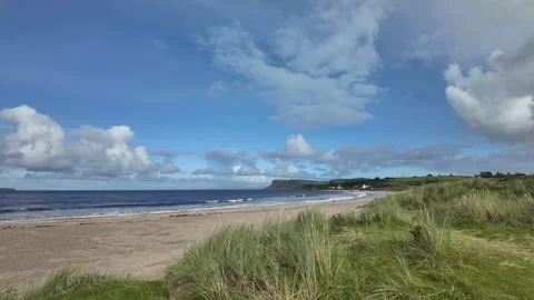 Time Lapse of Ballycastle Beach with visitors on Sunny Day and Blue Sky 動画素材 317237935